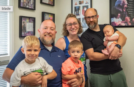 Dr. Anderson caring for a parent and child at Discover Chiropractic